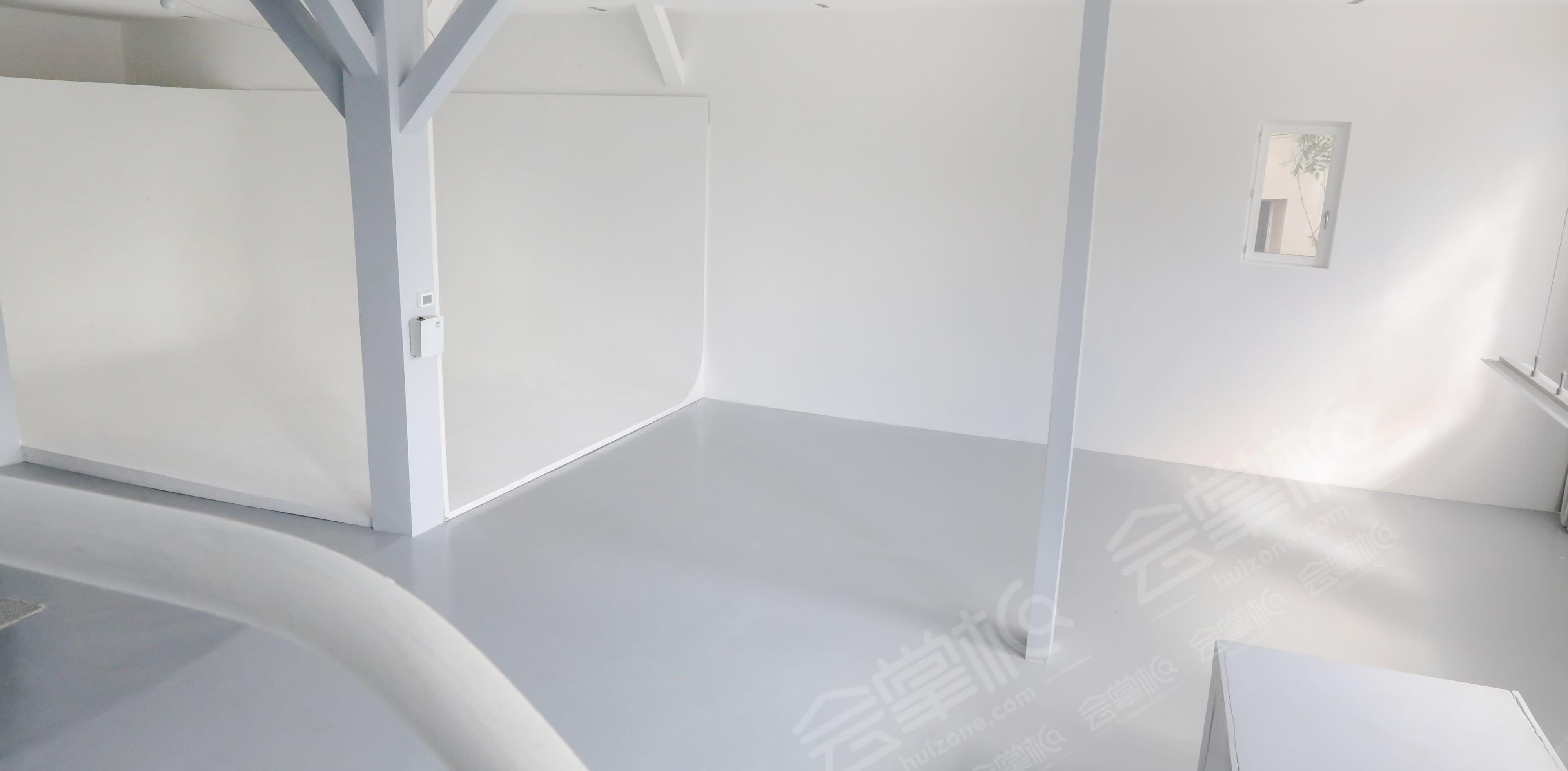 Studio minimaliste et spacieux avec grand mur vitré