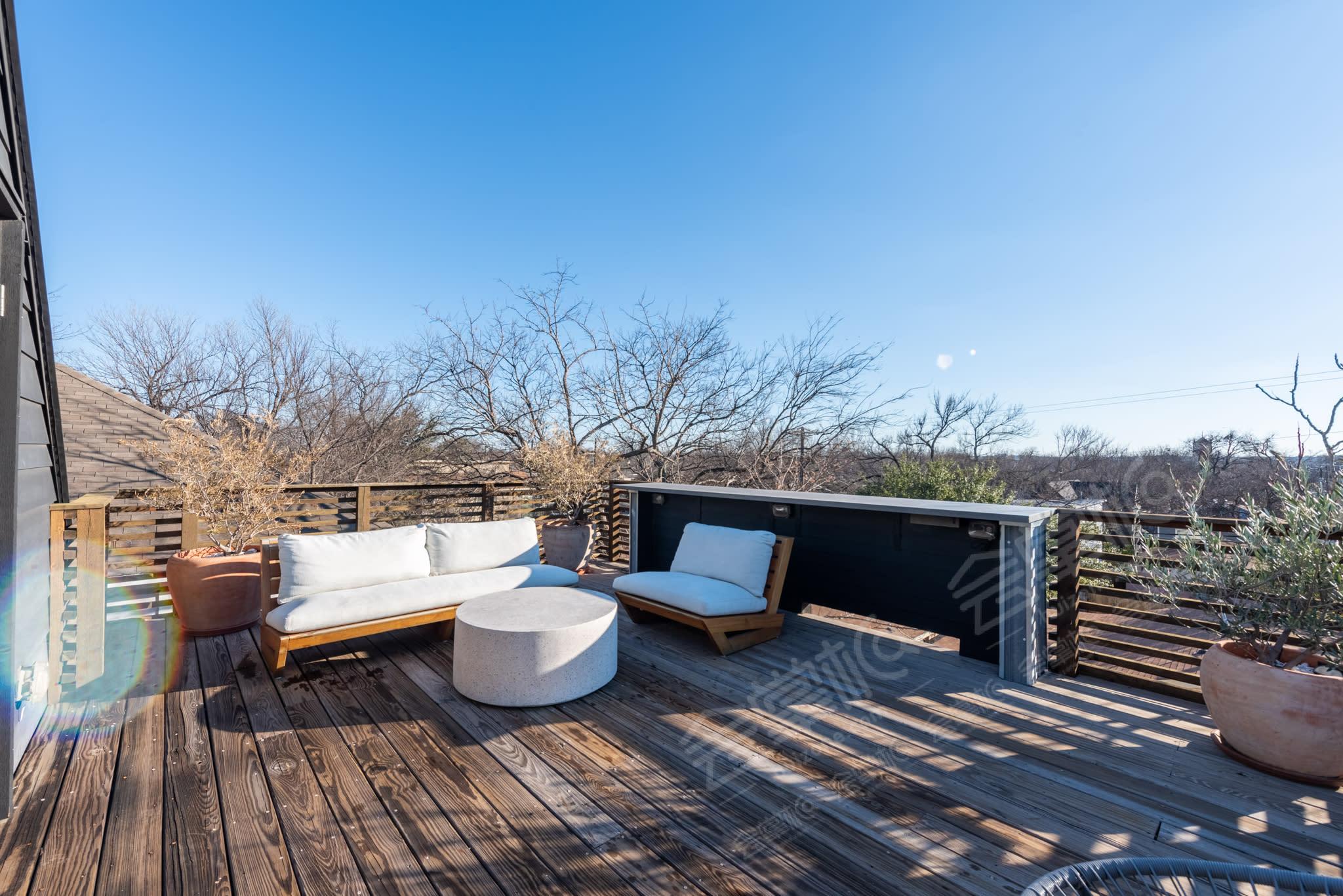 Modern farmhouse and rooftop deck with views of downtown Austin